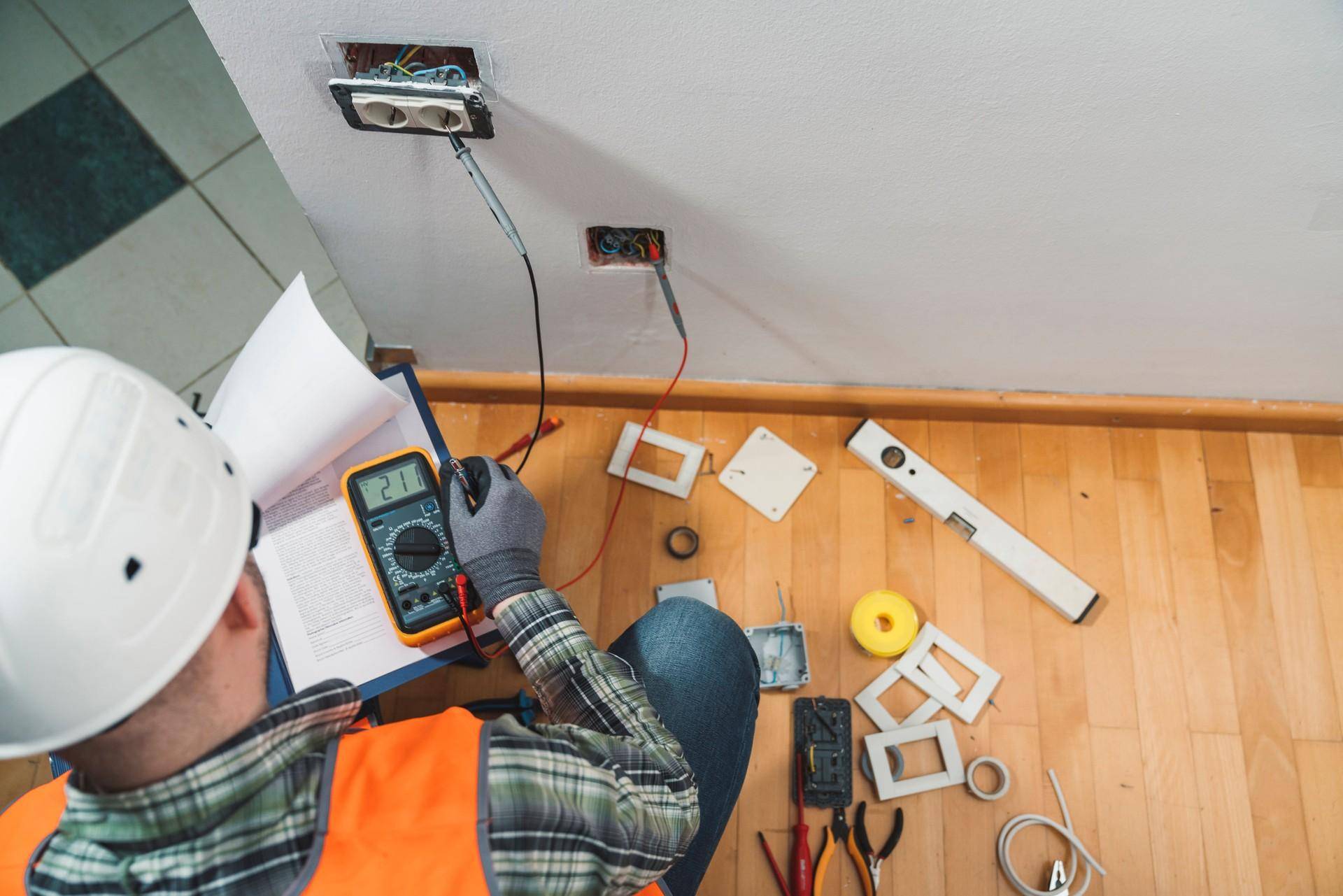 An electrician working and using different tools