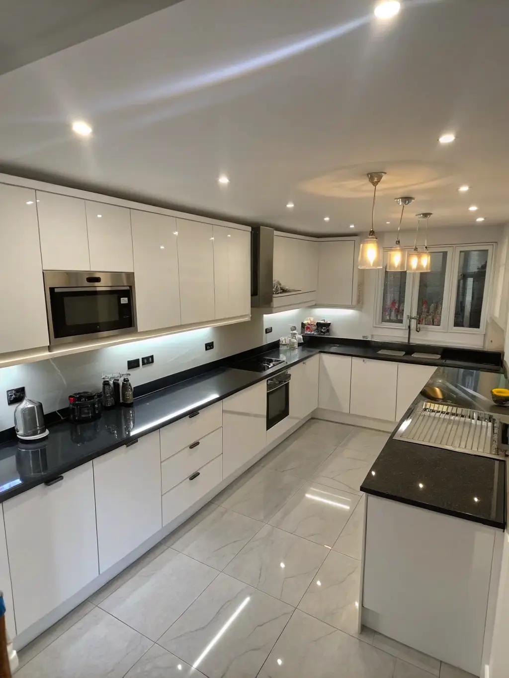 A modern kitchen with newly installed recessed lighting, highlighting the clean lines and even illumination provided by Omega Electric Inc.